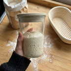 Hands holding Peak Dough proofing jar