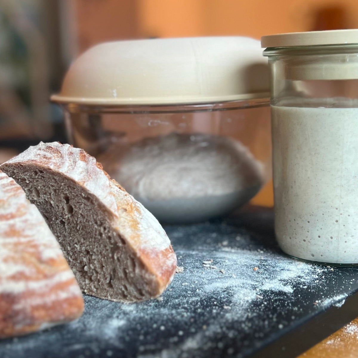 Sliced sourdough loaf next to Peak Dough jar