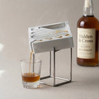 Ice Luge pouring bourbon into a crystal shot glass